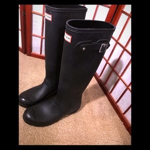 Lightly worn matte black Hunter boots.